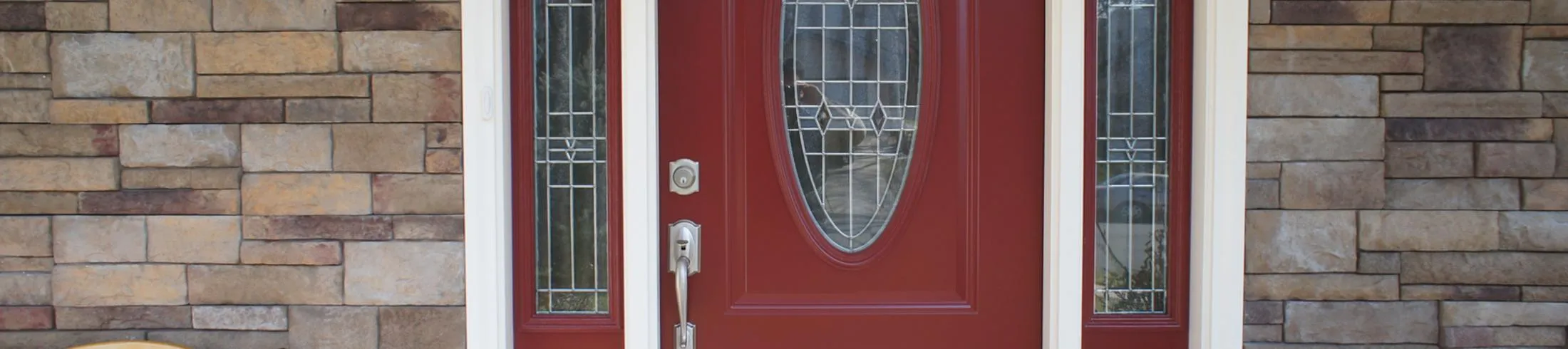 A red door with a stained glass window.