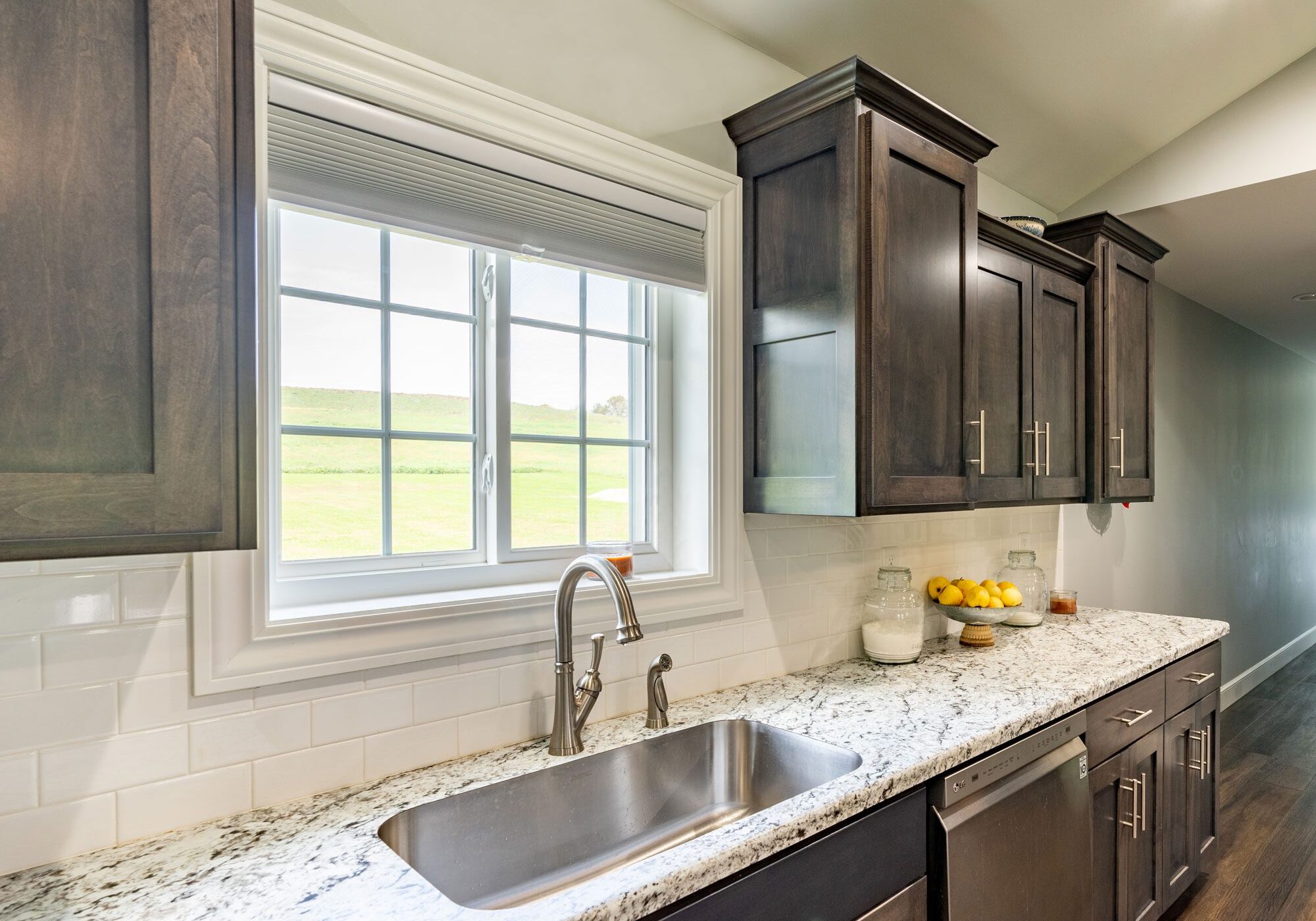 A kitchen with granite counter tops and stainless steel appliances.