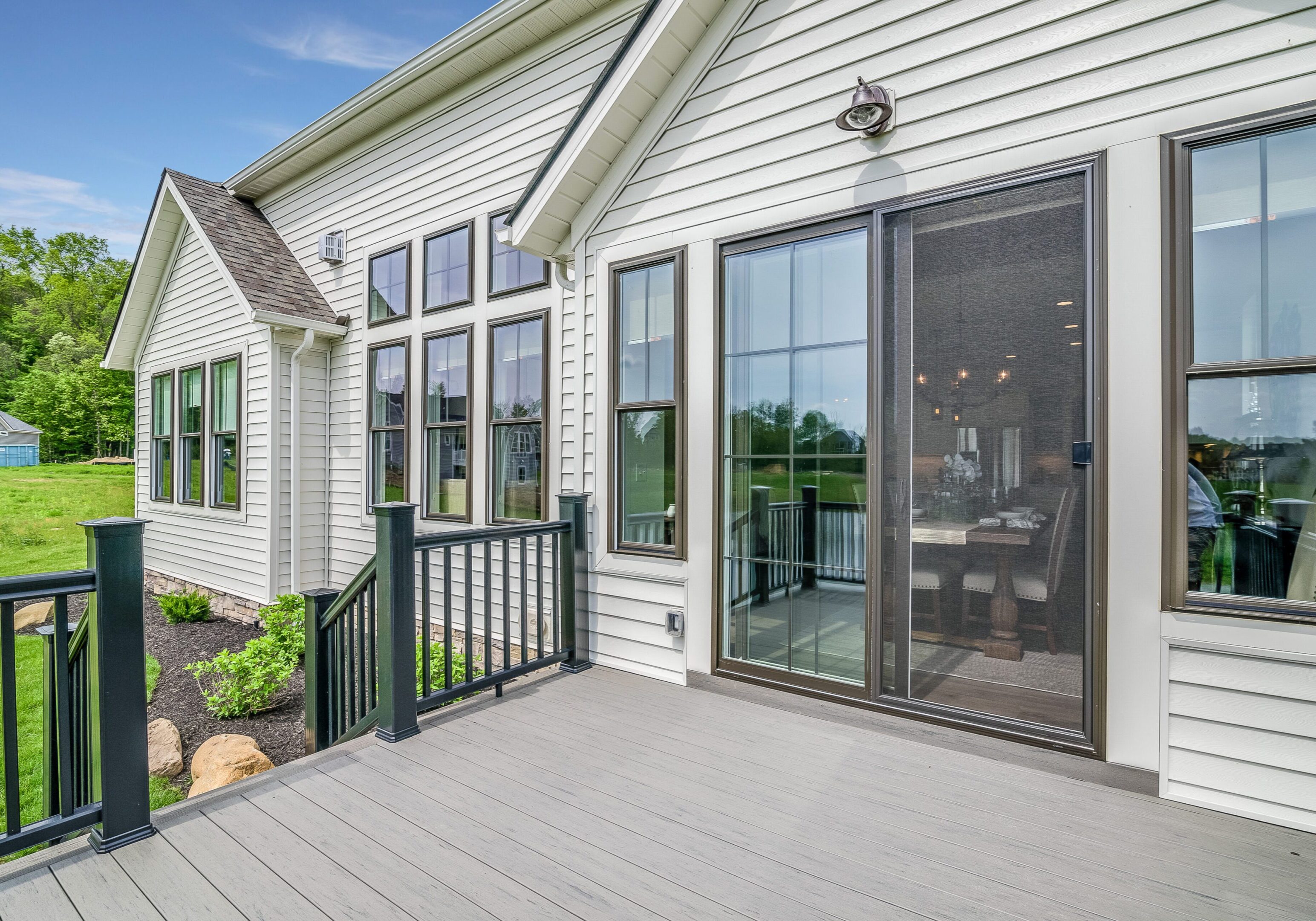 Modern house exterior with large glass doors.